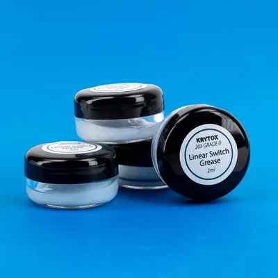 Displays the product clearly in a clean catalog-style format to show the physical appearance and packaging of the grease containers.