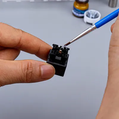 Demonstrates how to use the product (likely a soldering tool or precision screwdriver) to perform detailed repair or assembly work on small electronic components. Shows the product's ability to…