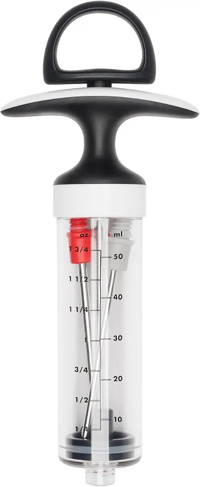 Provides a clean, catalog-style view of the meat injector product showing its full design, handle, plunger, and measurement markings on the transparent barrel.