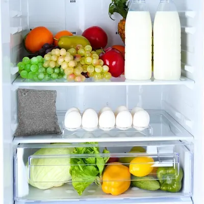Demonstrates the product in a real-world kitchen context, showing how it keeps food fresh and organized in a refrigerator setting.