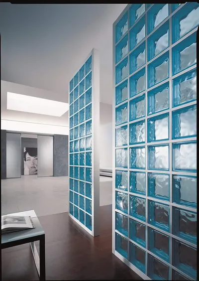 Demonstrates the product (glass blocks) installed in a real-world modern interior setting to show shoppers how it looks and functions as a design element in an actual space.