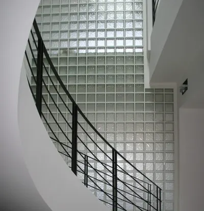 Showcases the product (glass blocks) installed in a real-world architectural setting to demonstrate its aesthetic appeal and practical application in modern interior spaces.