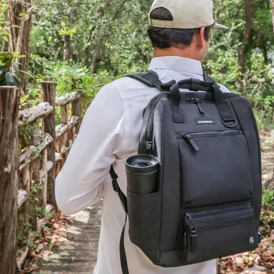 Demonstrates the backpack in an outdoor hiking context, showing its suitability for active pet owners on trails and outdoor adventures.