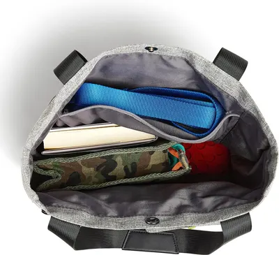Displays the interior contents and organizational features of the tote to demonstrate storage capacity and what can be carried inside.