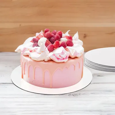 Shows the product in use in a real kitchen setting, helping shoppers visualize how the cake boards look when supporting an actual decorated cake.