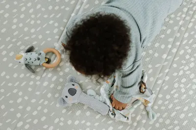 Provides a natural overhead perspective of the baby playing with the toys to show real-world usage and engagement.