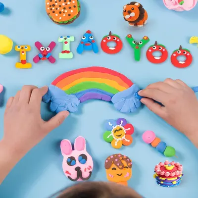 Shows children actively using the clay product in a real-world creative play scenario to help shoppers visualize the product in use.