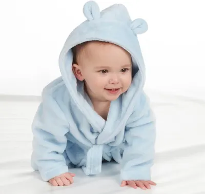 Shows the baby bathrobe being worn by a child in a real-world context to help shoppers visualize the product in use.