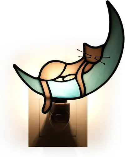 Shows the nightlight plugged in and glowing to demonstrate its warm ambient light and charming decorative design.