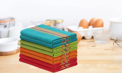 Shows the full 12-pack stacked neatly on a kitchen counter in a real-world setting, helping shoppers visualize the product quantity and storage.