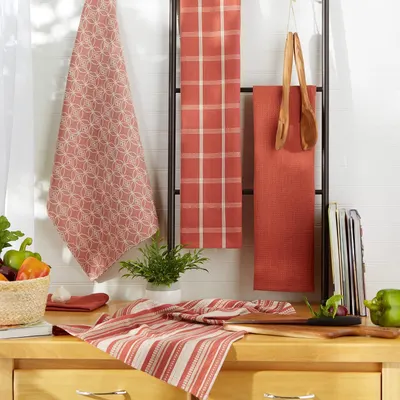 Shows the dishtowels hanging and displayed in a real kitchen environment to help shoppers visualize how they look in use.