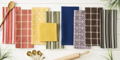 Displays the full range of color and pattern options available in the brand's dishtowel collection to help shoppers choose their preferred style.