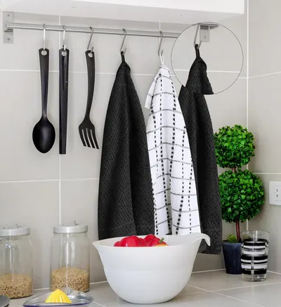 Demonstrates the towels hanging in a kitchen environment with a loop feature highlighted to show practical storage and usage in a real-world setting.