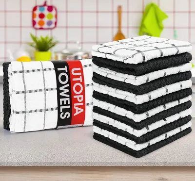 Shows the full set of towels stacked together in a kitchen environment to communicate the quantity and visual appeal of the complete package.
