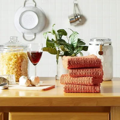 Shows the towels in a real kitchen environment to help shoppers visualize how the product fits into their home.