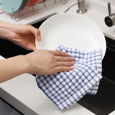 Shows the product in real-world use drying a dish in a home kitchen setting.