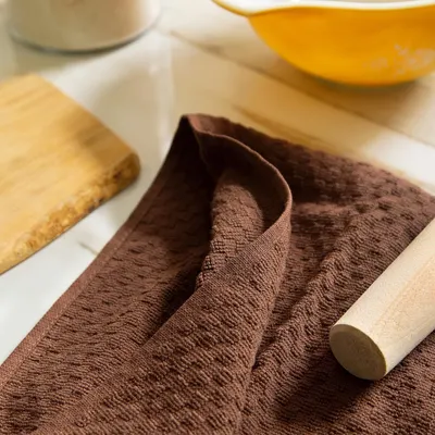 Shows the mat in a real kitchen environment with baking tools to demonstrate practical everyday use.