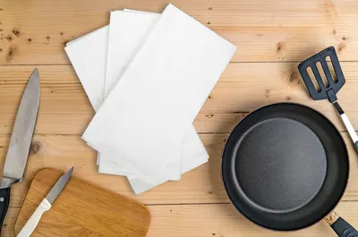 Shows the towels in a real kitchen setting with cooking tools to help shoppers visualize the product in use.