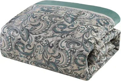 Shows the folded comforter to display the reversible design and overall pattern of the bedding set.