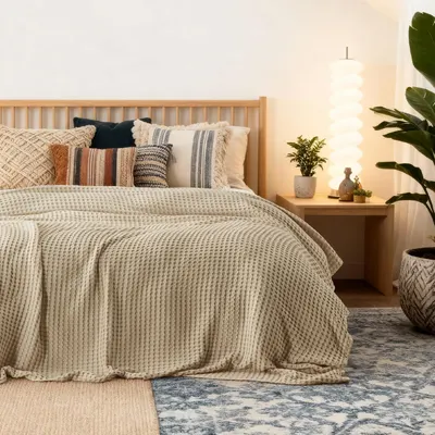 Shows the blanket styled in a real bedroom setting to help shoppers visualize the product in their own home.