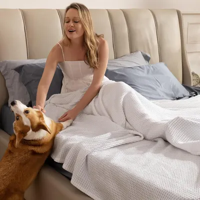 Displays the product in a real-world lifestyle setting with a person and pet, showing comfort and everyday use without any text overlay.