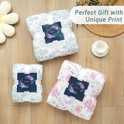 Positions the blanket as a perfect gift option by showing multiple folded blankets with decorative packaging labels, appealing to gift-giving occasions.