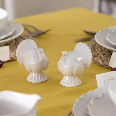 Showcases the turkey shakers as part of a Thanksgiving table setting to emphasize their seasonal appeal and decorative function for holiday entertaining. Shows the product in a real-world holiday…