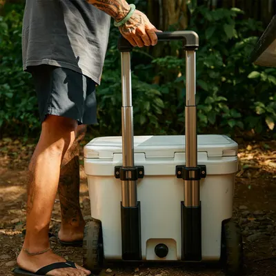 Demonstrates the cooler being used in a real outdoor setting to show its practical application and ease of transport.