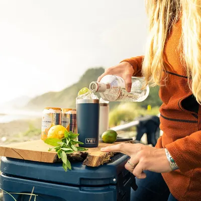 Shows the tumbler in a real-world outdoor setting to help shoppers visualize using the product during leisure activities.