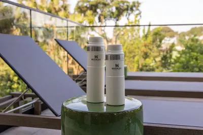 Presents the water bottles in an outdoor lifestyle setting to help shoppers envision the product in their daily life.