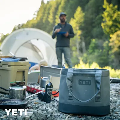 Shows the product in a real-world camping environment to help shoppers visualize using the bag outdoors.