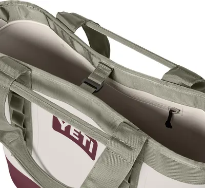 Shows a close-up detail of the bag's handles and interior sleeve on a clean white background with no text or design elements.
