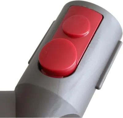 Shows a close-up detail of the red button mechanism on the attachment to highlight its physical component and functionality.