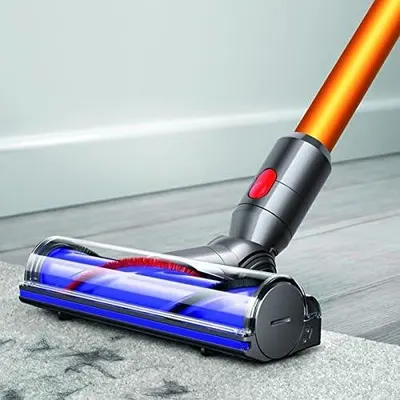 Shows the vacuum's floor cleaning head in action on a hard floor surface, demonstrating real-world usage without text or callouts.