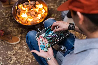 Demonstrates the product being used to store jewelry and small items in an outdoor camping setting, showing versatility without text.