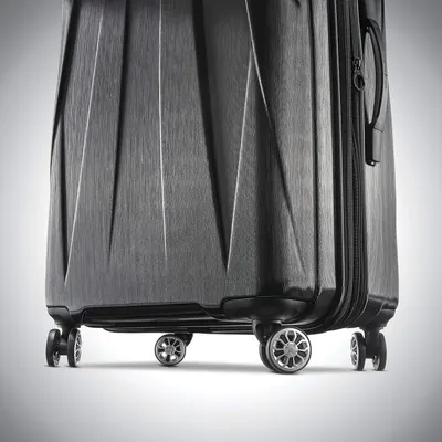 Close-up of the spinner wheels and brushed hardside shell reassures shoppers the case rolls smoothly and looks durable.