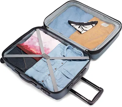Shows clothes held in place by the packing straps, reassuring shoppers the interior keeps packing organised.