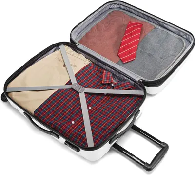 Shows the open suitcase packed with shirts, trousers and a tie, so shoppers can picture everyday packing.