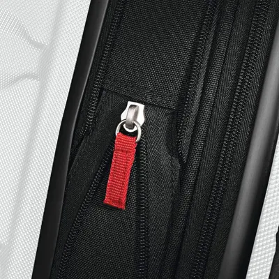 Close-up of the expansion zipper with a red pull tab shows the easy-to-grip zip that opens the extra space.