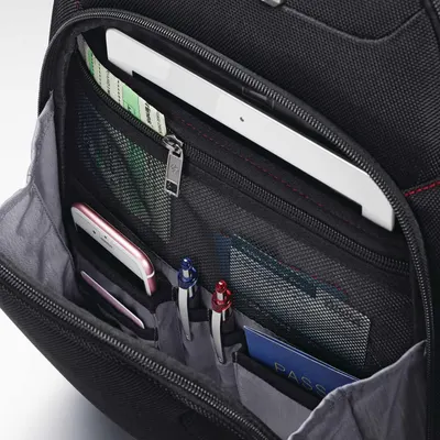 Close-up of pockets holding a phone, tablet, pens and passport shows where everyday items fit.