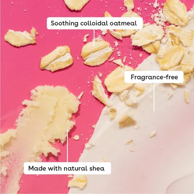Three labelled callouts on a close-up texture highlight the soothing oatmeal, fragrance-free formula and natural shea, reassuring sensitive-skin shoppers about gentle ingredients.