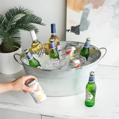 Shows the bucket styled in a living space with ice and drinks to inspire entertaining.