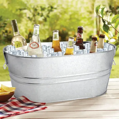 Shows the tub filled with chilled drinks outdoors to communicate its practical everyday use for gatherings.
