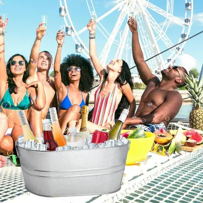 Shows the tub used at a lively group party on a boat to suggest versatile social use.