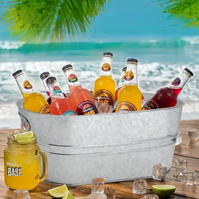 Presents the tub filled with drinks in a beach setting to show its suitability for outdoor serving.
