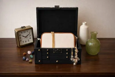 Shows the chest holding a purse, jewelry, and decor to demonstrate its multiple storage and display uses.