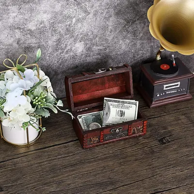 Shows the box holding cash to communicate its practical storage capacity.