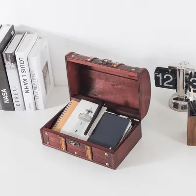 Shows the open chest holding office items to demonstrate practical desktop storage.
