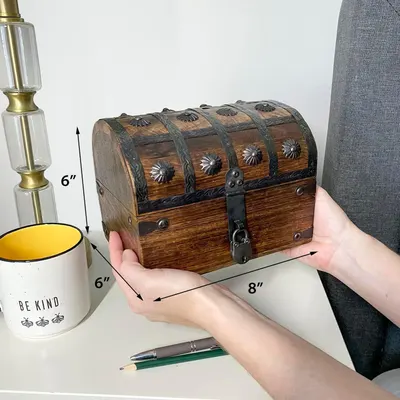 Shows exact physical dimensions of the chest so shoppers know how big it is before buying. Reinforces that the chest is small enough to sit on a desk alongside everyday items.