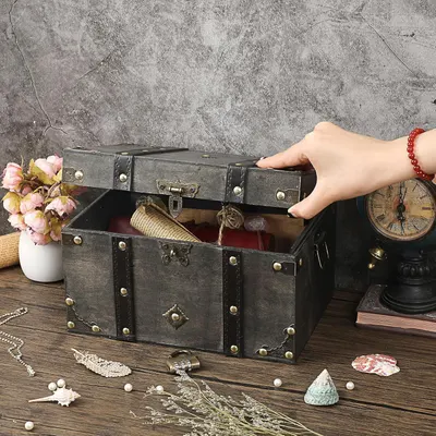 Shows the chest holding keepsakes in a styled setting to communicate its use for treasured items.